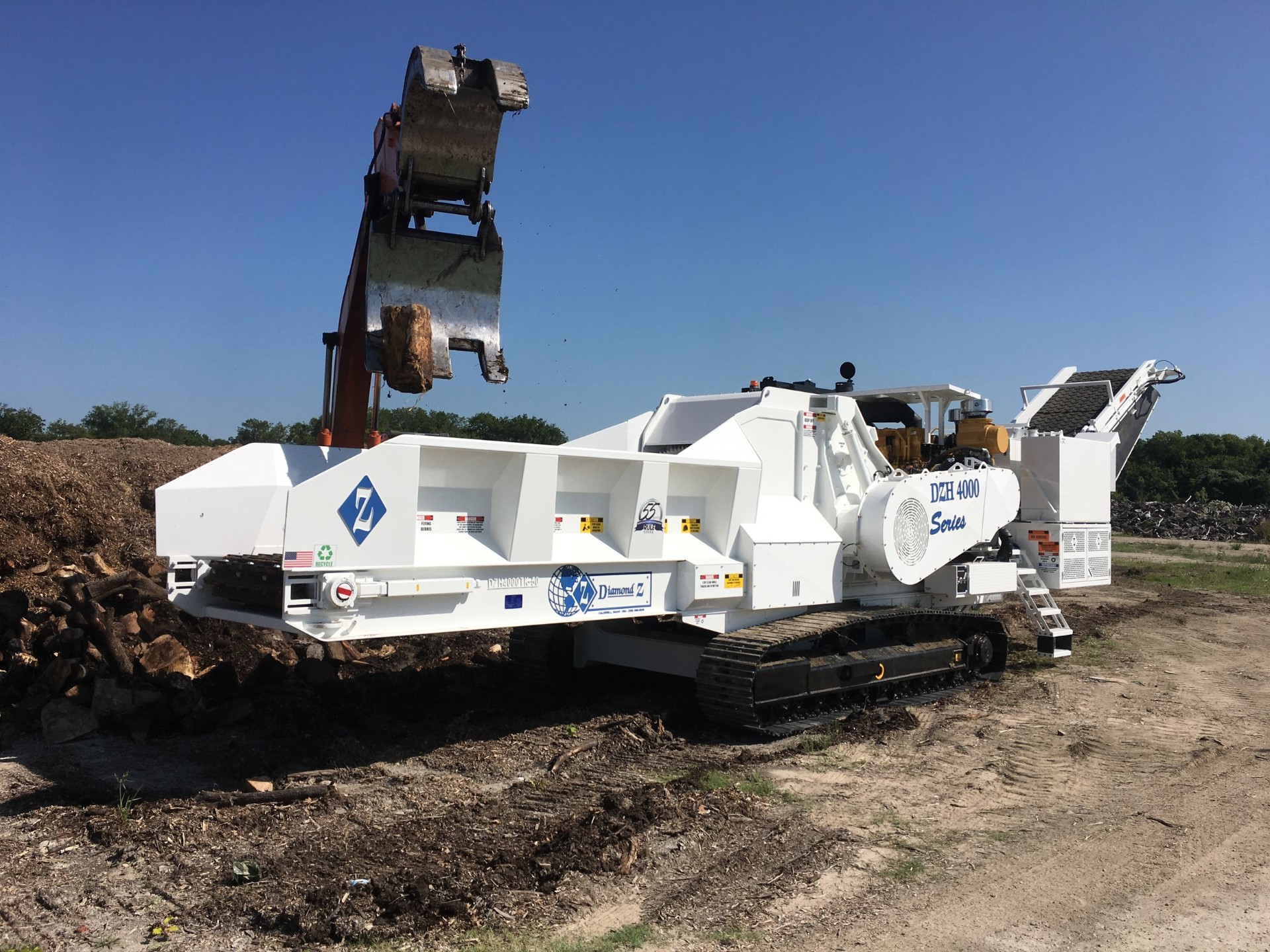 Diamond Z horizontal grinder processing land clearing debris in Memphis, TN